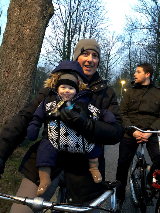 happy baby in baby carrier on bike