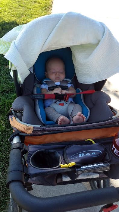 cute baby sleeping in car seat in stroller