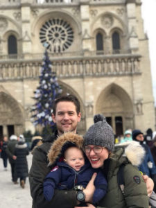 family with baby at notre dame at christmas