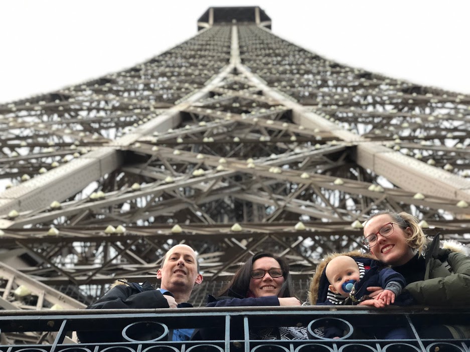 family with baby on eiffle tower