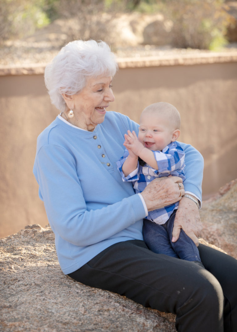 older grandma holding clapping baby