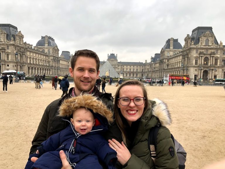 family in front of the louvre in paris