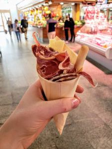 cone of meat and cheese in barcelona mercado for cheap