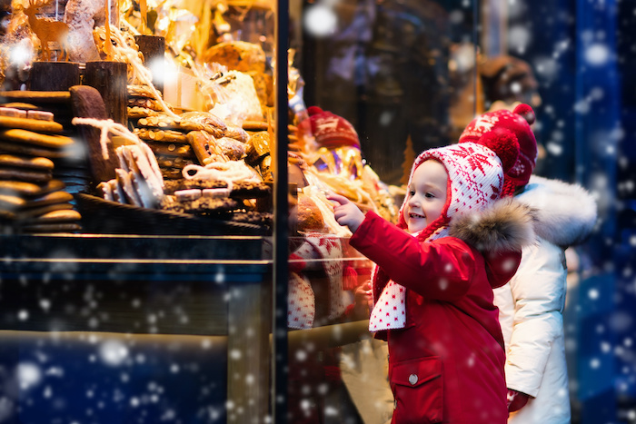 kids looking in bakery window in paris in winter