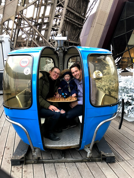family in gondola on the eiffel tower in paris in winter