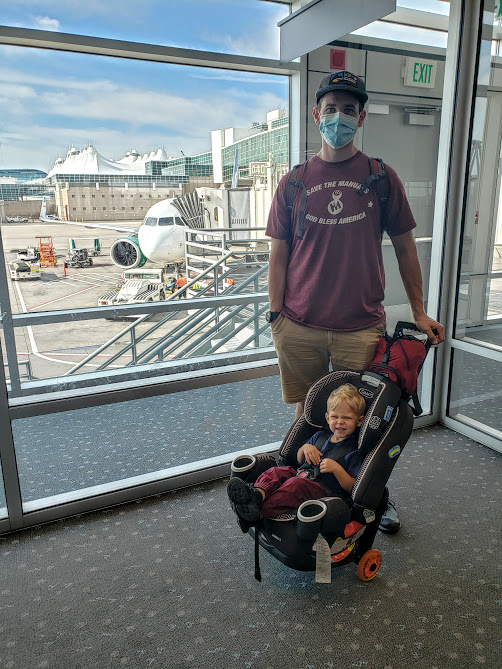 dad and baby with mask for flying during covid